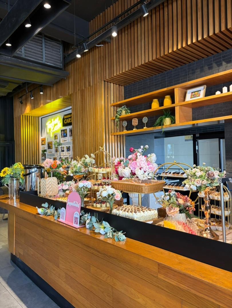 Elegant dessert and floral catering counter setup at a corporate event